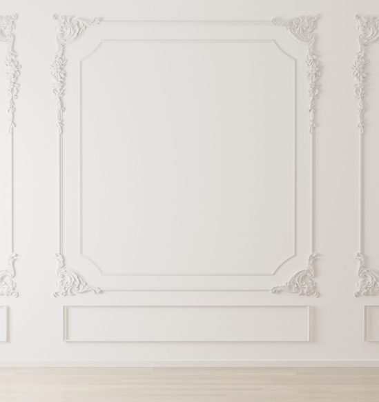 White wall with classic style mouldings and wooden floor, empty